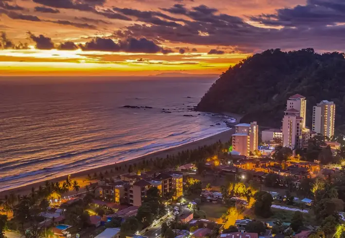 Aerial view of Jacó bay and skyline at dusk